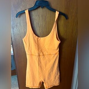 Orange workout romper, stretchy material, soft